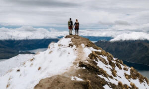 Two people atop a mountain